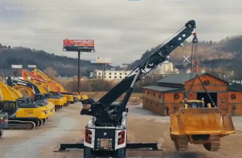Flatbed tow truck recovering a broken down vehicle on I-240 near downtown Asheville NC