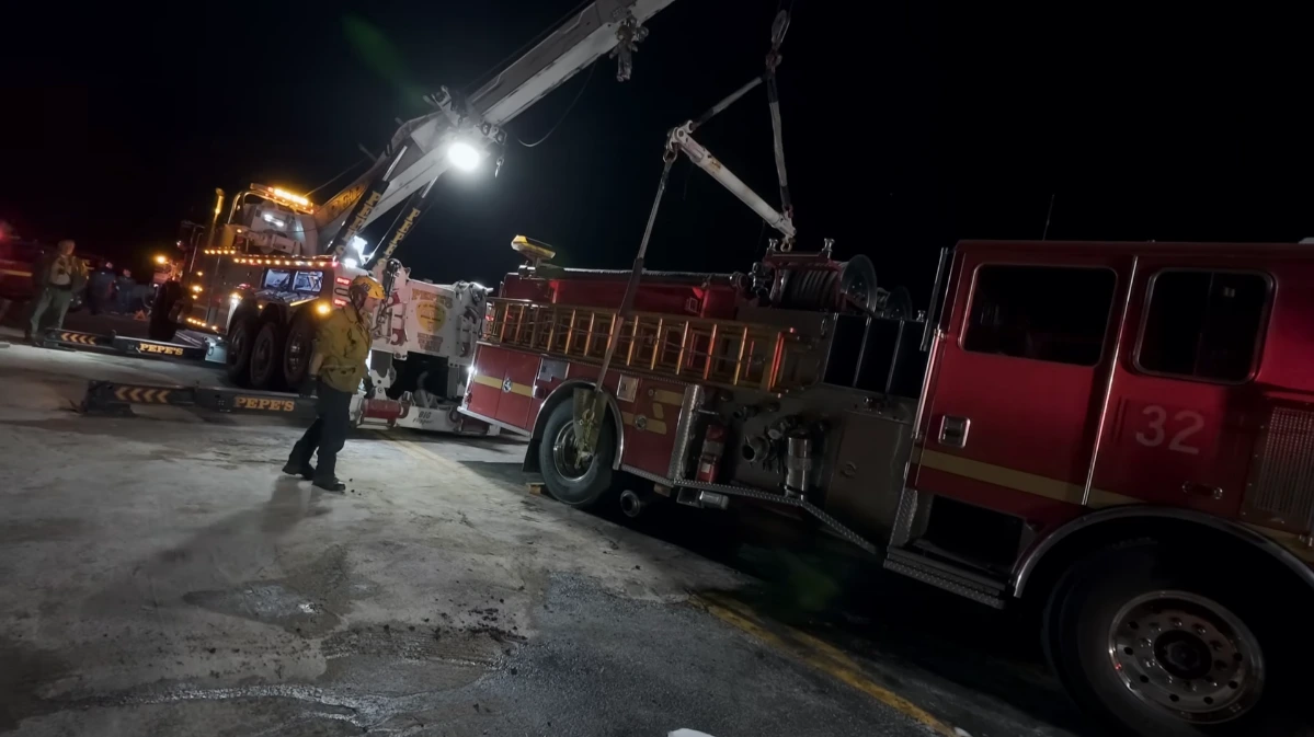 Emergency tow truck arriving at a roadside breakdown at night in Asheville NC
