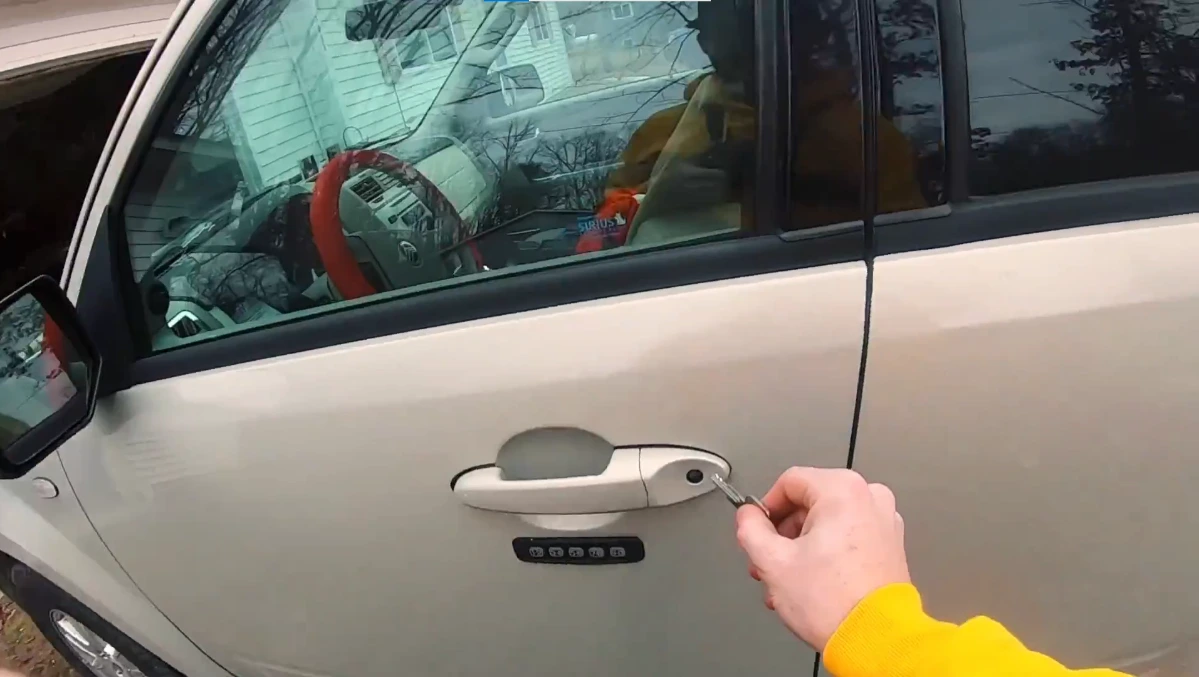 Locksmith technician performing a car lockout service without damage in Asheville NC