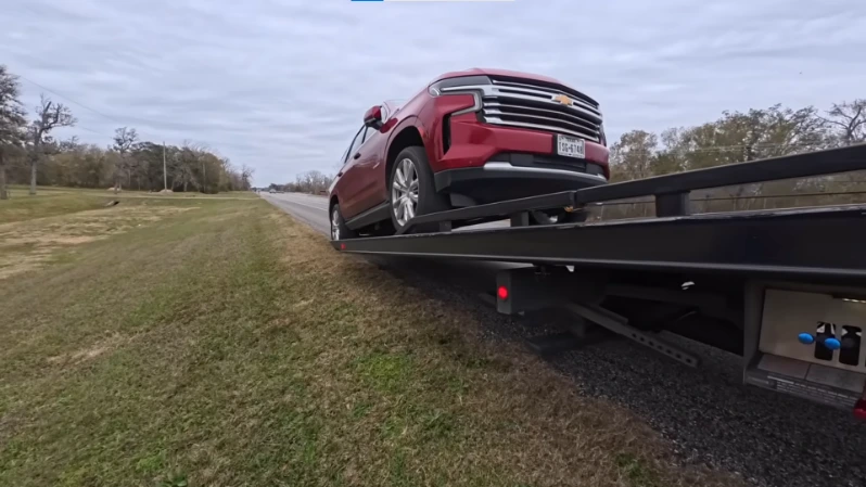 Non-running classic car on flatbed being transported from Asheville NC to Knoxville TN