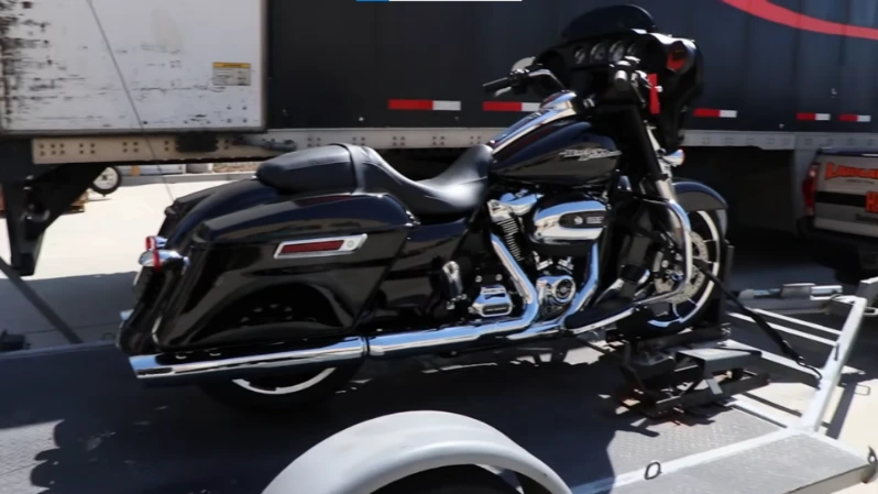 Motorcycle secured on flatbed with wheel chocks and soft straps for transport in Asheville NC