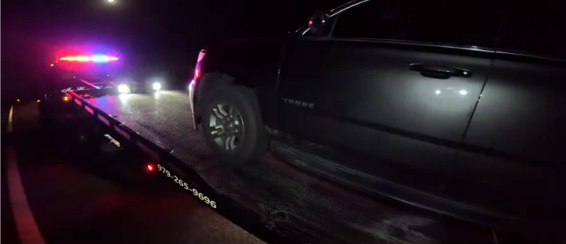 Tow truck responding to a night-shift worker stranded with a dead battery in Asheville NC