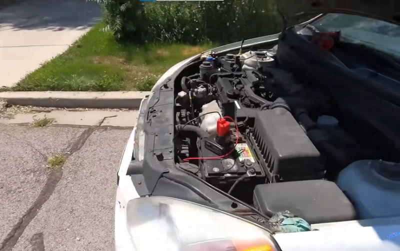 Roadside assistance battery jump start at a trailhead parking area near Asheville NC