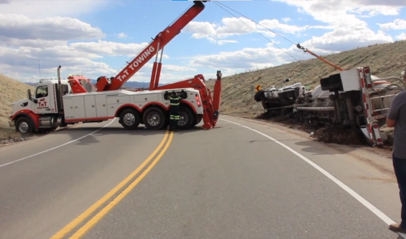 Tow truck recovering a delivery van broken down on US-70 in the Swannanoa industrial corridor.